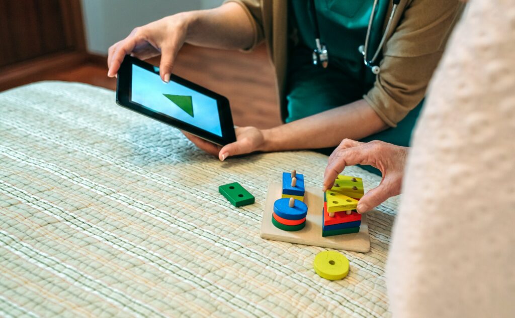 Female doctor showing geometric shapes to elderly patient